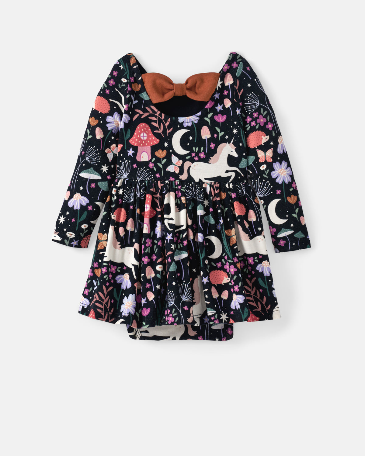 A baby girl's long-sleeve dress with a whimsical fantasy print featuring unicorns, mushrooms, moons, and stars on a black background, finished with a contrasting rust-brown bow at the back.