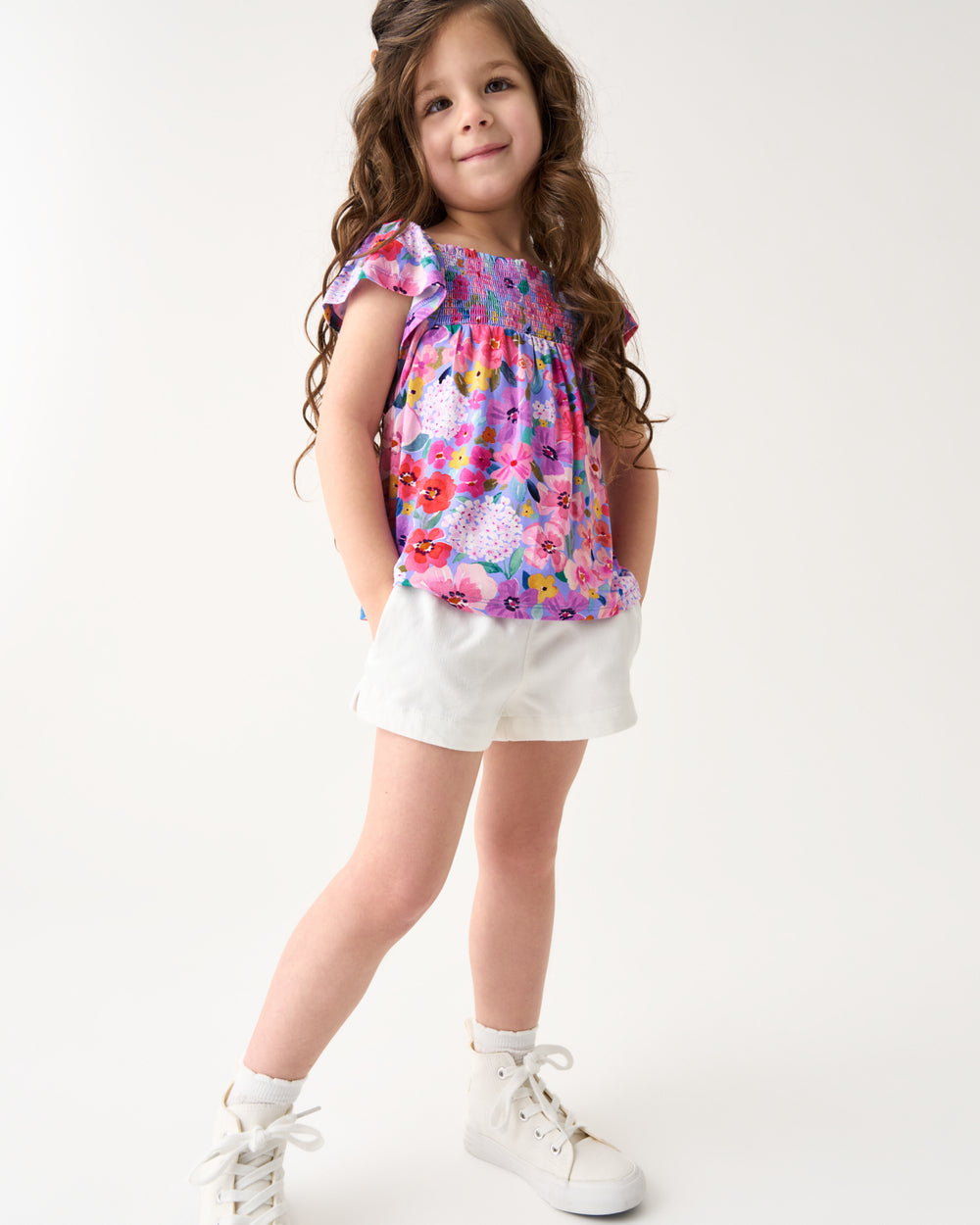 Girl wearing the Sweet Sprigs Smocked Flutter Top