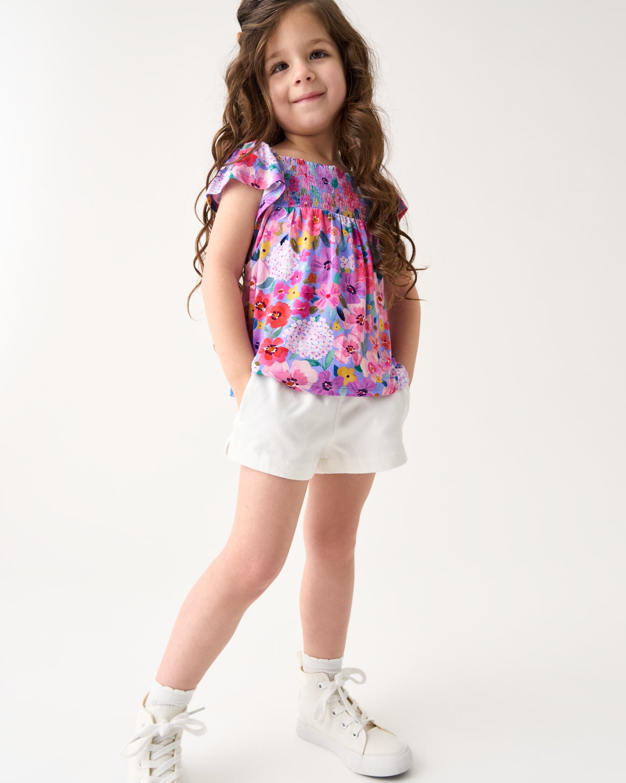 Girl wearing the Sweet Sprigs Smocked Flutter Top