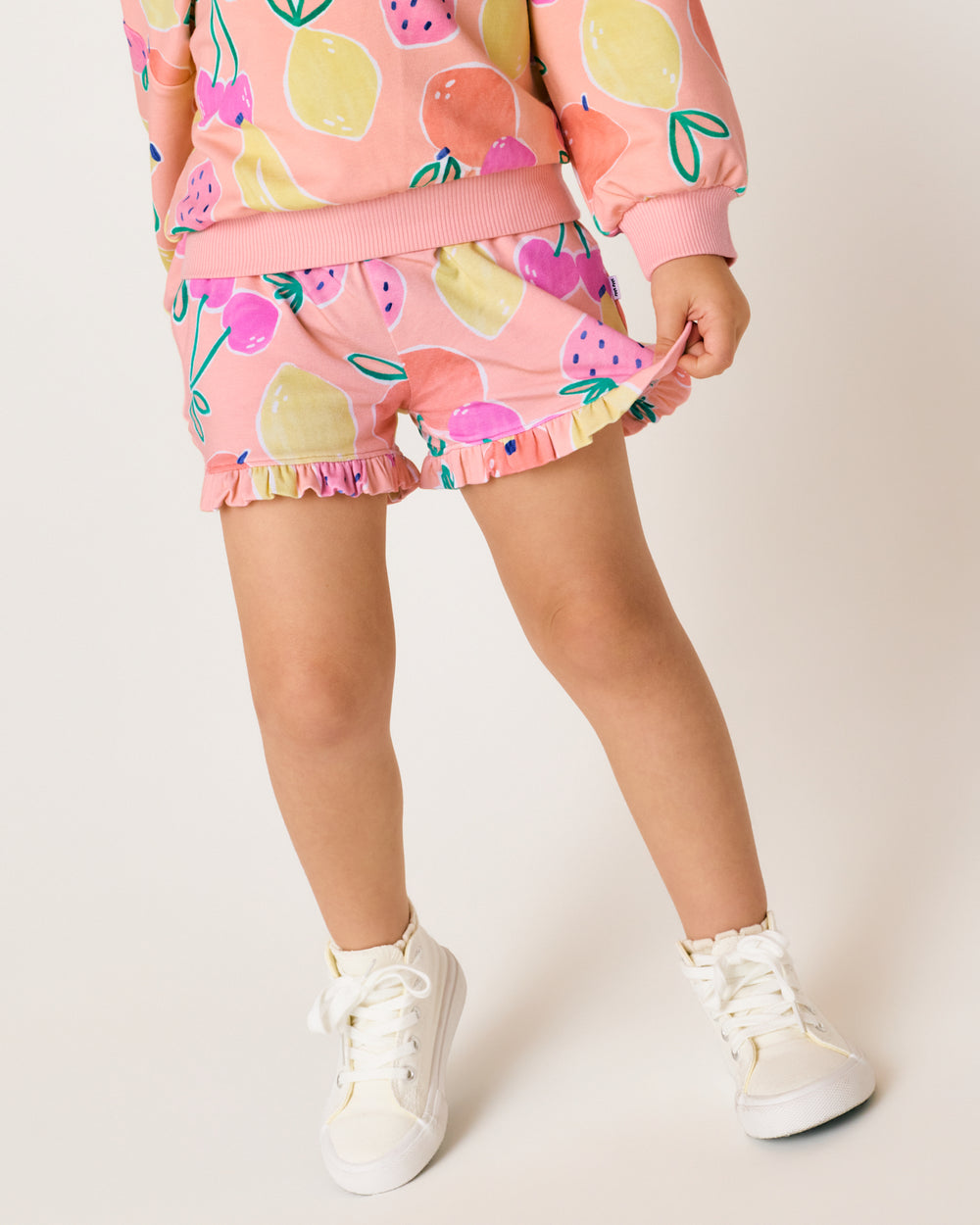 Close up of girl wearing the Fruit Frenzy Ruffle Shorts