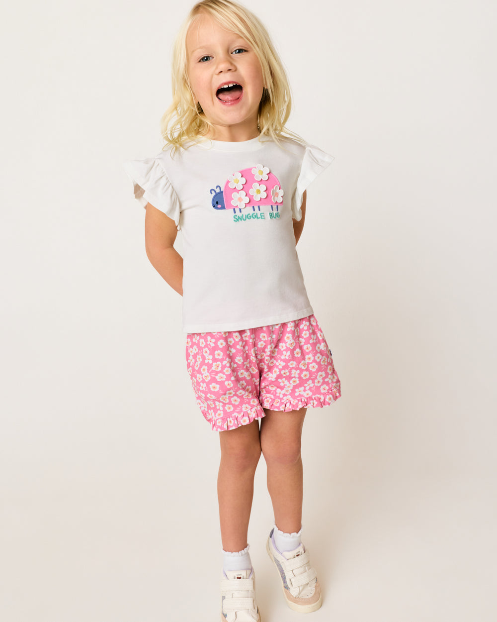 Alternate child wearing the Sweet Pink Petals Ruffle Shorts with the Snuggle Bug Flutter Tee