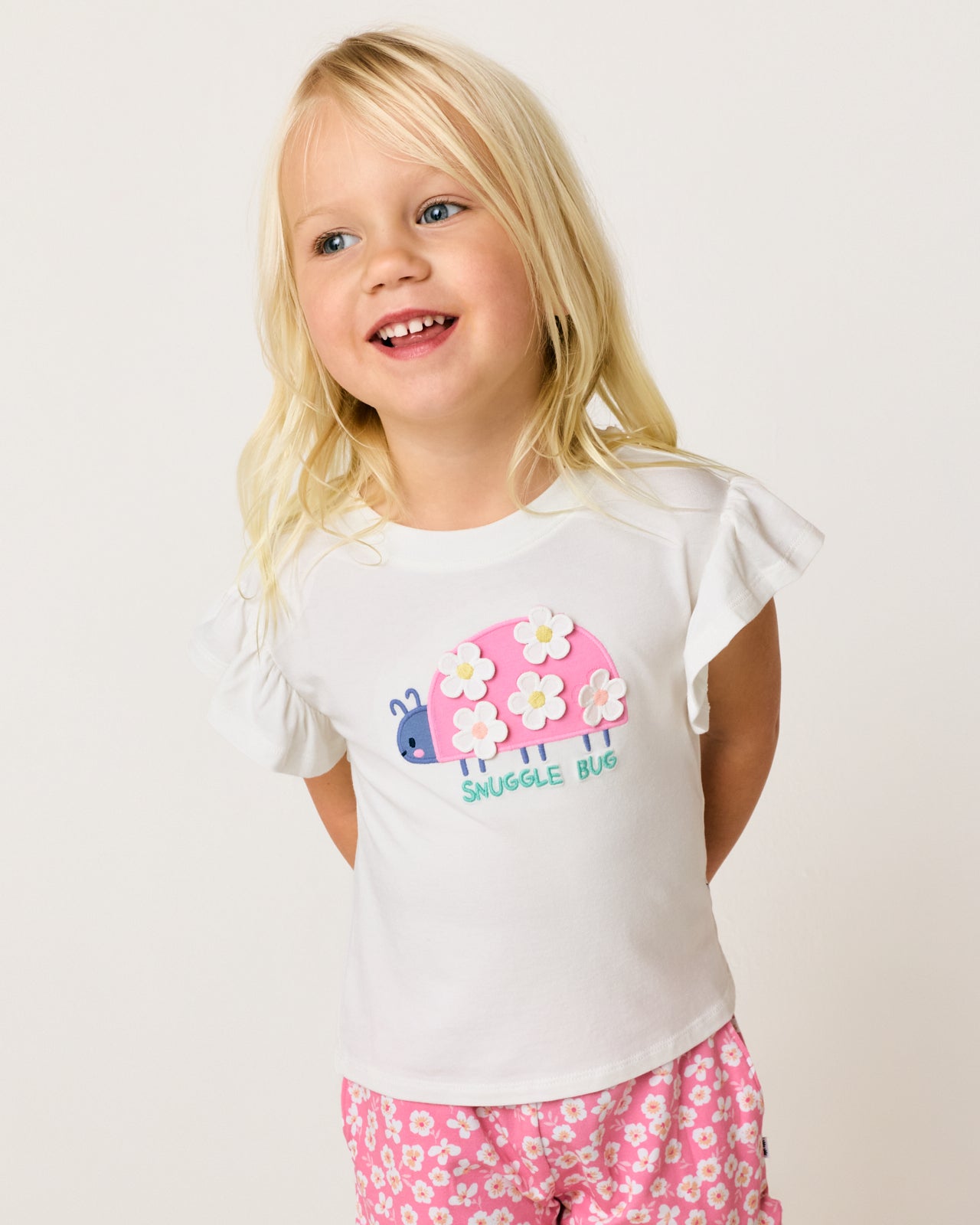 Close up of girl wearing the Snuggle Bug Flutter Tee