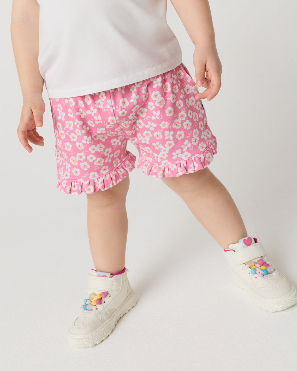 Close up of child wearng the Sweet Pink Petals Ruffle Shorts