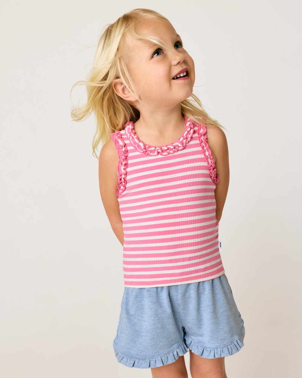 Girl wearing the Sweet Pink Stripe Ruffle Tank with Heather Blue Ruffle Shorts