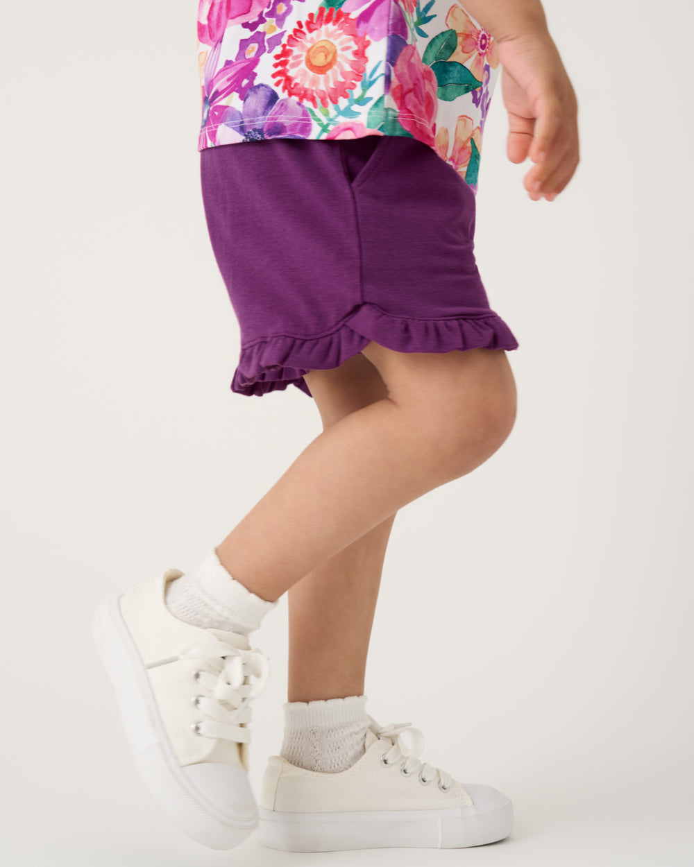 Side view of child wearing the Royal Violet Ruffle Shorts