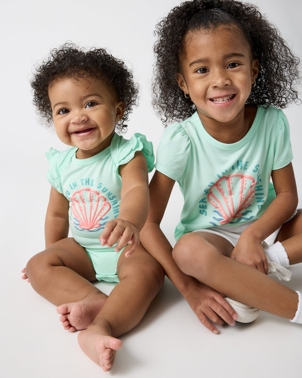 Two girls wearing matching Sparkling Seas play styles