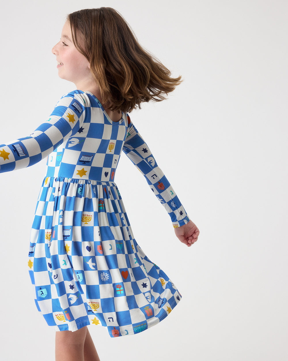 Girl in motion wearing the Hanukkah Checks Skater Dress