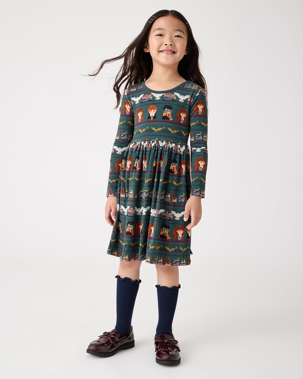 Girl wearing the Harry Potter™ Spellbinding Studies Skater Dress with ruffle socks