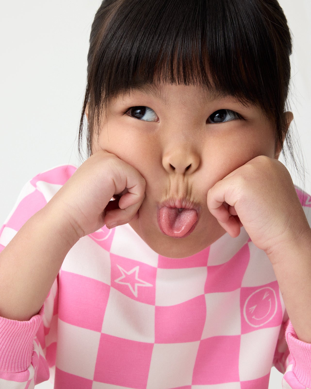 Girl wearing the Cheery Checks Pink Drop Shoulder Sweatshirt