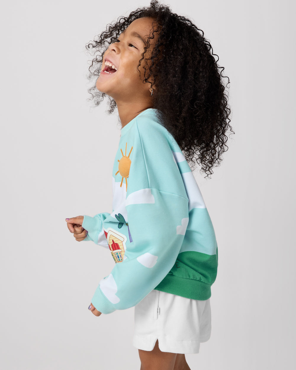 Side view of girl wearing the Bluey The Heeler House Drop Shoulder Crewneck