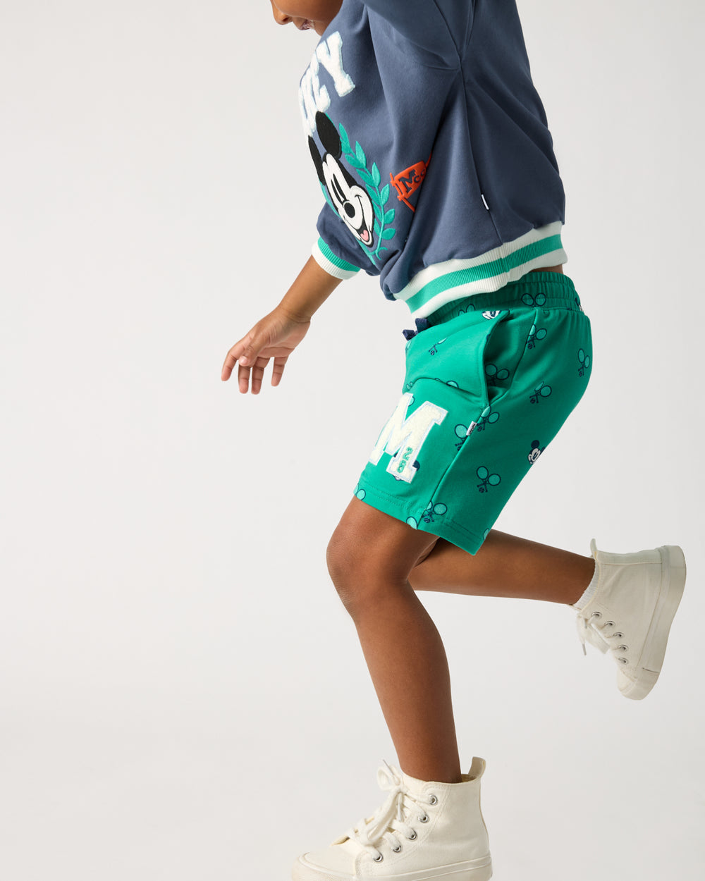 Child in motion wearing the Disney Mickey Mouse Racket Rally Drawstring Shorts