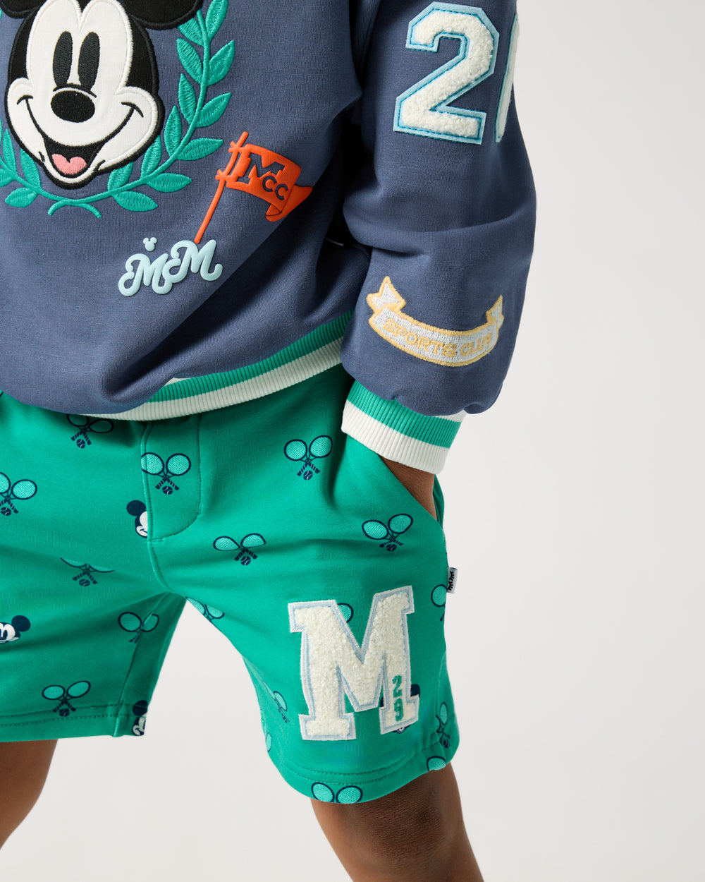 Boy wearing the Disney Mickey Mouse Racket Rally Drawstring Shorts with his hand in the pocket