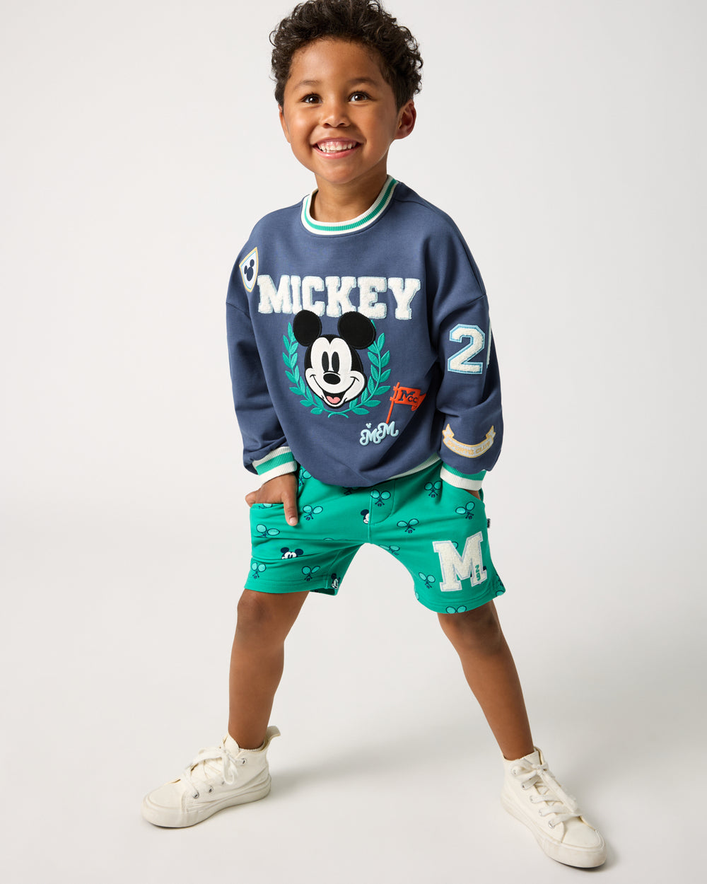 Boy wearing the Disney Mickey Mouse Sports Club Drop Shoulder Crewneck and Shorts