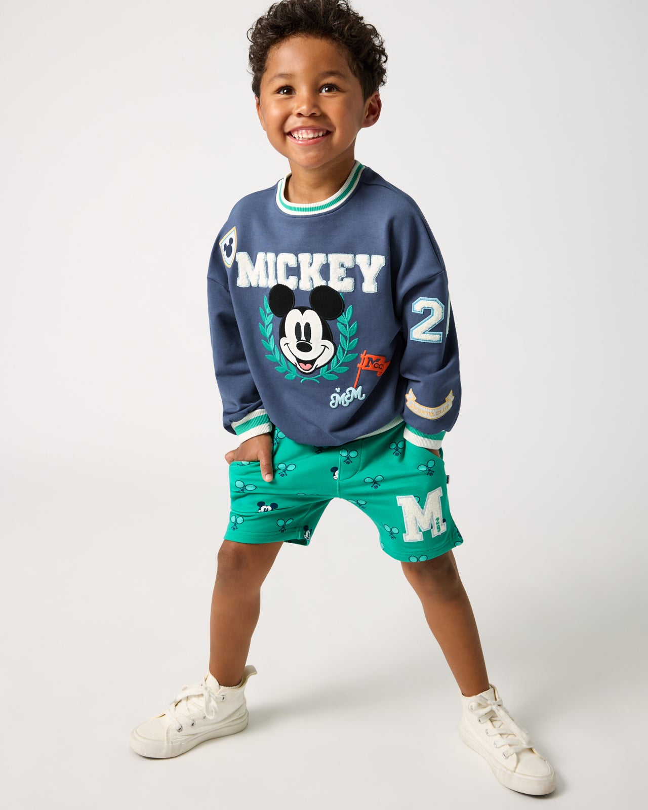 Boy wearing the Disney Mickey Mouse Sports Club Drop Shoulder Crewneck and Shorts