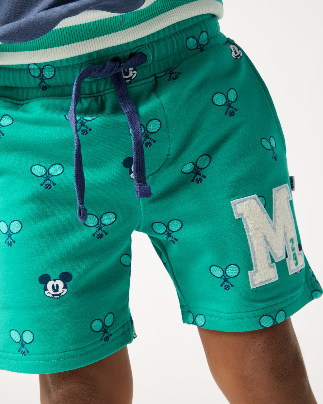 Boy wearing the Disney Mickey Mouse Racket Rally Drawstring Shorts