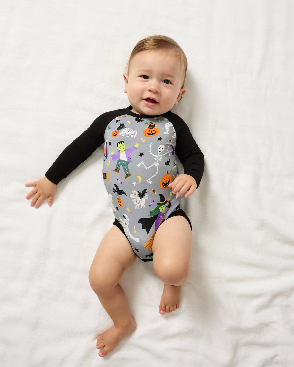 Aerial view of baby wearing the Dracula's Disco Raglan Bodysuit