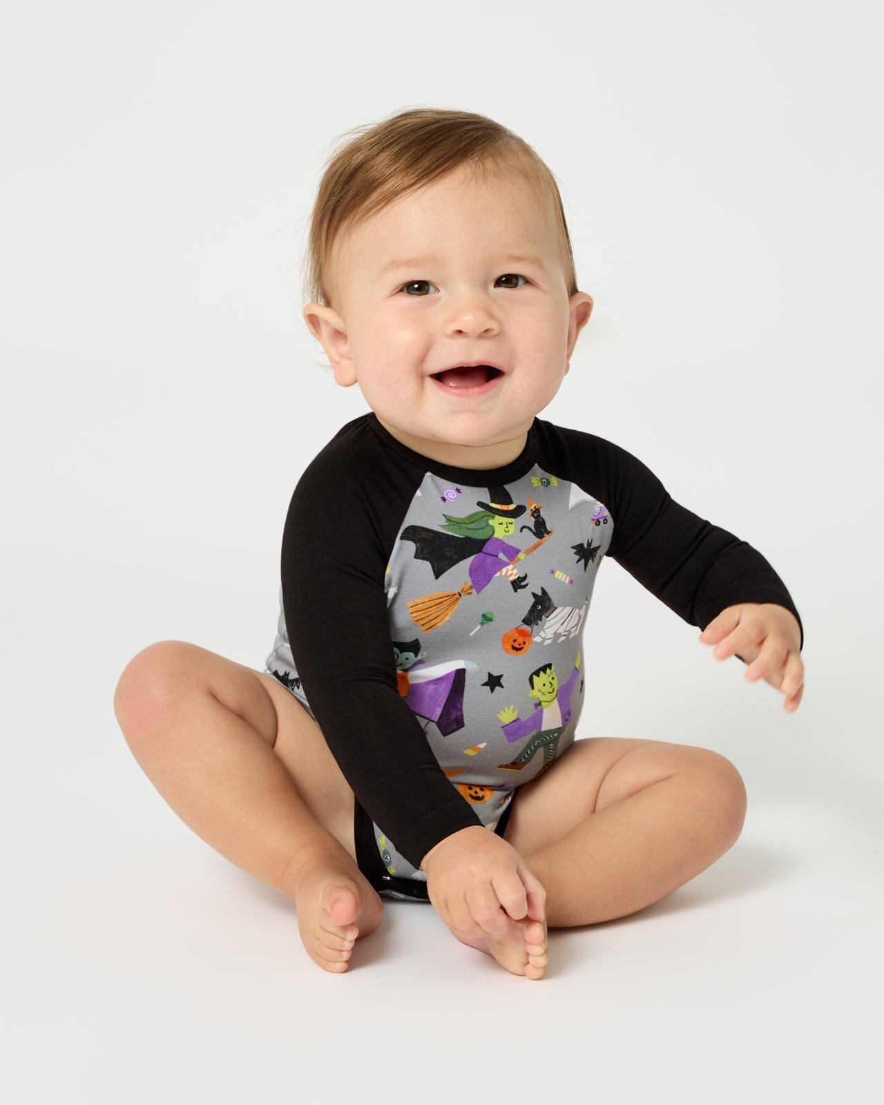 Sitting baby wearing the Dracula's Disco Raglan Bodysuit