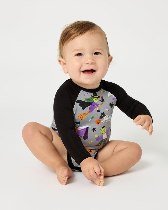 Sitting baby wearing the Dracula's Disco Raglan Bodysuit
