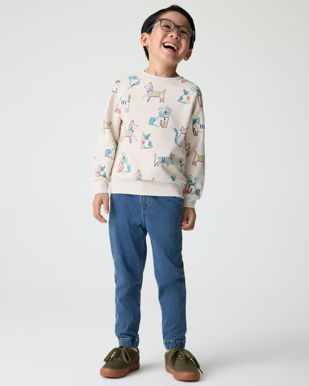 Boy wearing the Whiskers & Wags Crewneck Sweatshirt with denim joggers