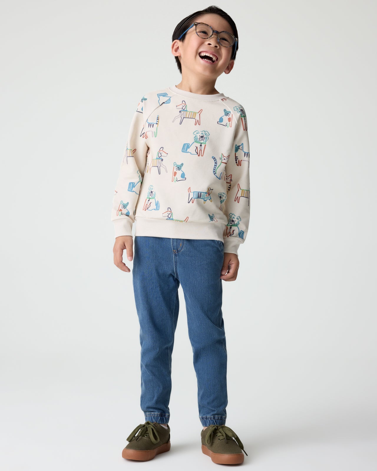 Boy wearing the Whiskers & Wags Crewneck Sweatshirt with denim joggers