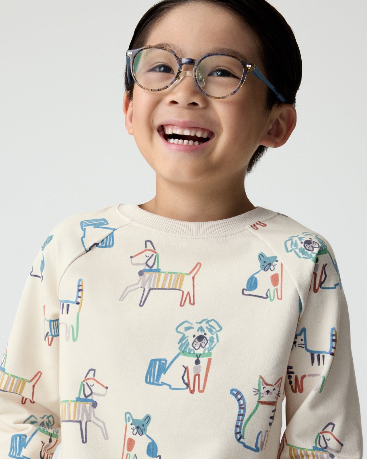 Close up of boy wearing the Whiskers & Wags Crewneck Sweatshirt