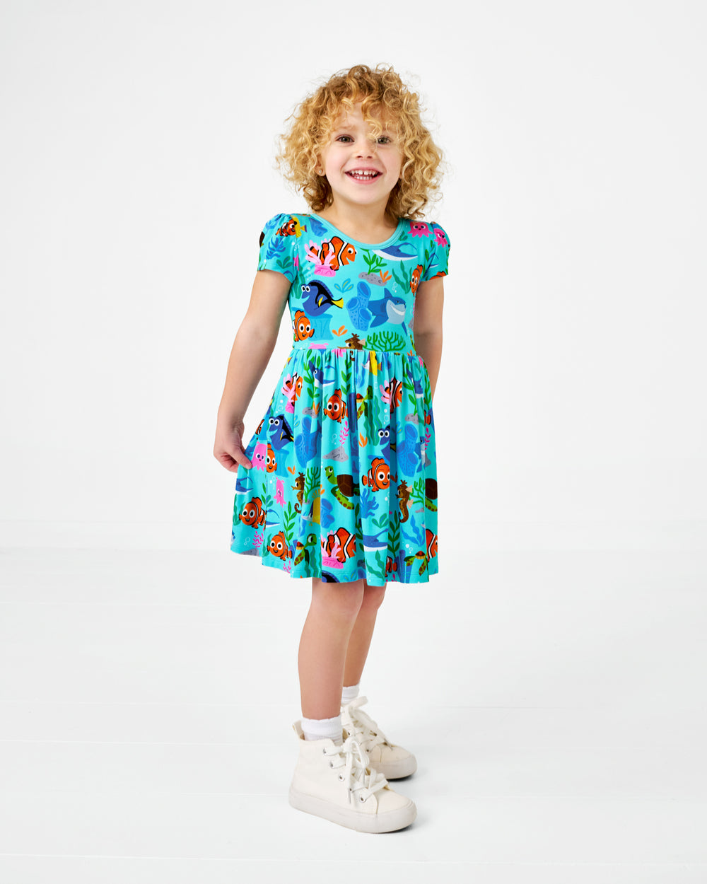 Standing child wearing the Disney Nemo's Reef Skater Dress