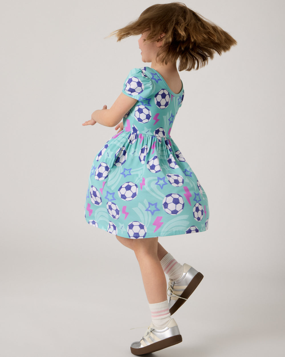 Twirling girl wearing the Aqua Soccer Stars Skater Dress