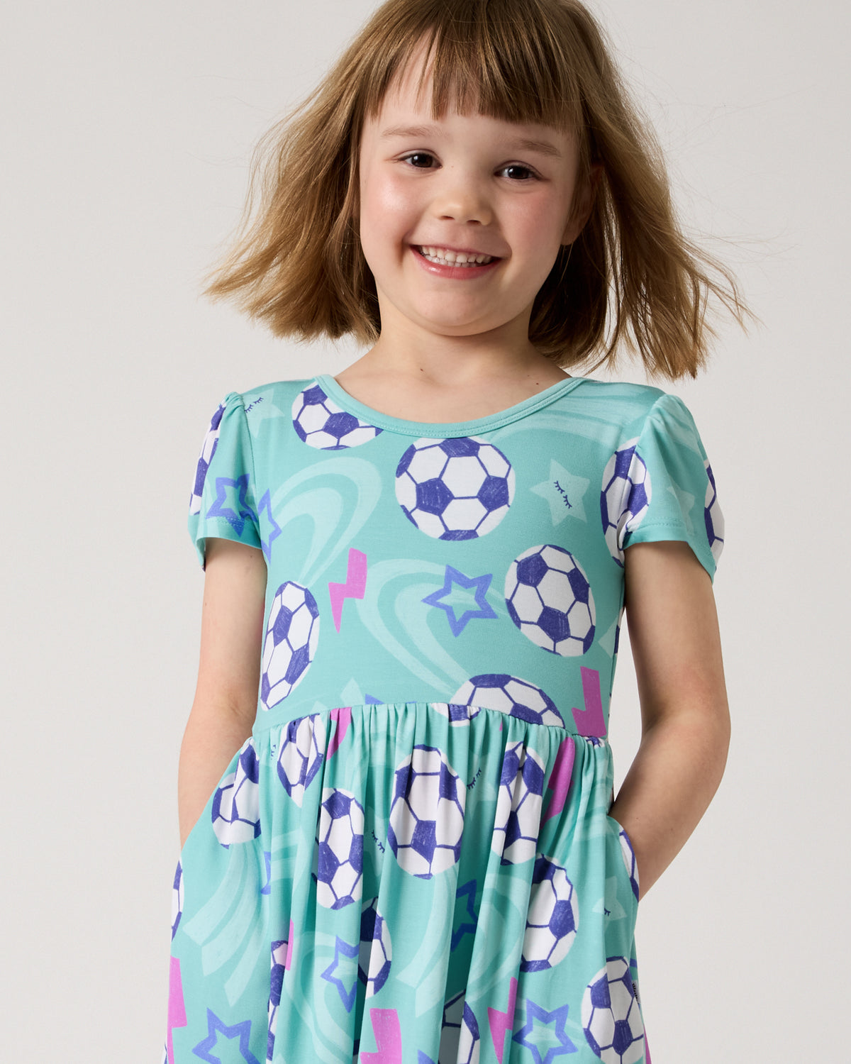 Close up of girl wearing the Aqua Soccer Stars Skater Dress