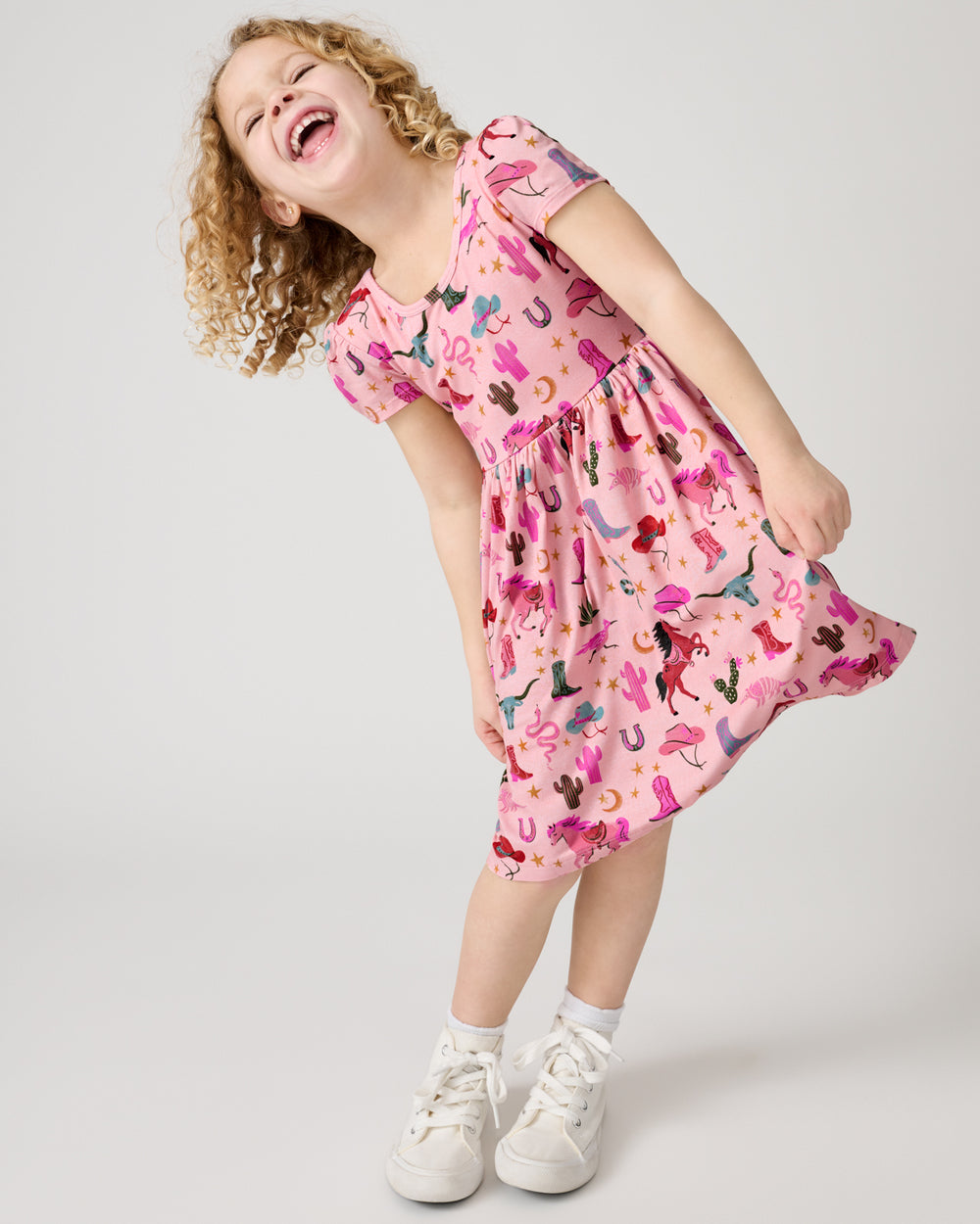Laughing girl wearing the Pink Rancher Roundup Skater Dress