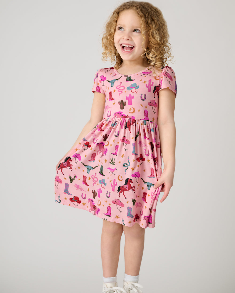 Standing child wearing the Pink Rancher Roundup Skater Dress
