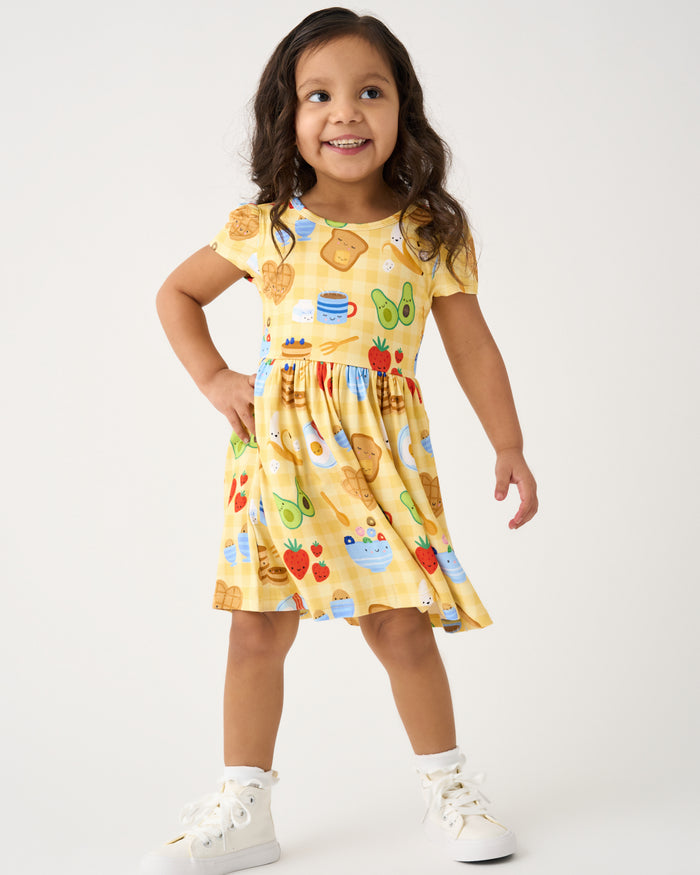 Standing girl wearing the Breakfast Bunch Skater Dress