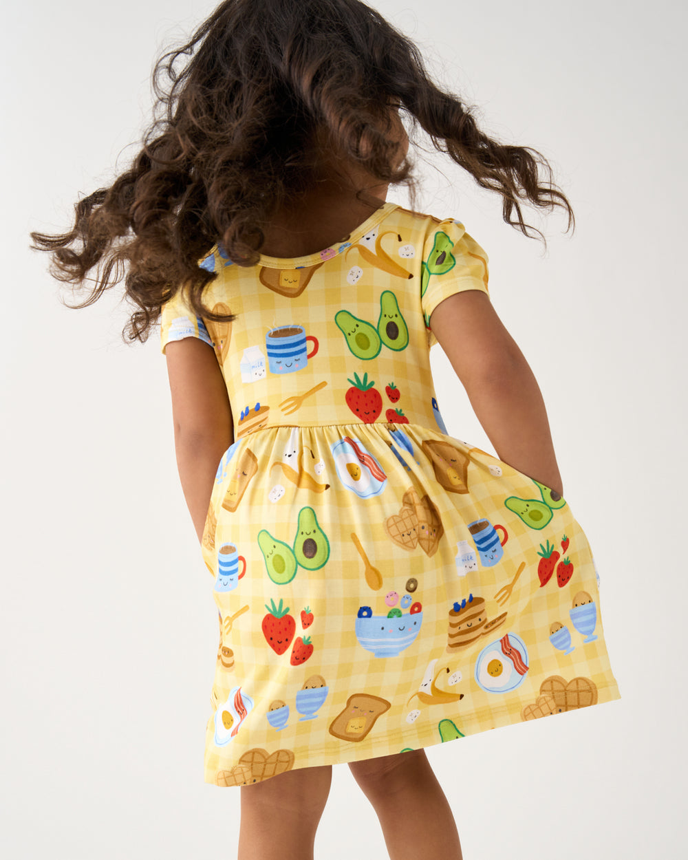 Back view of girl wearing the Breakfast Bunch Skater Dress