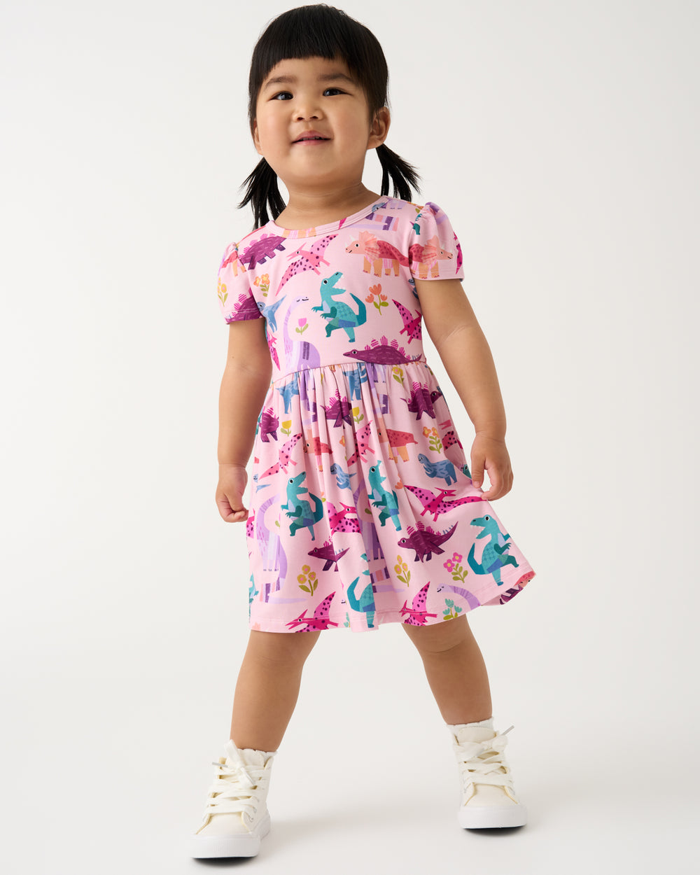 Girl wearing the Roar & Explore Skater Dress with white sneakers
