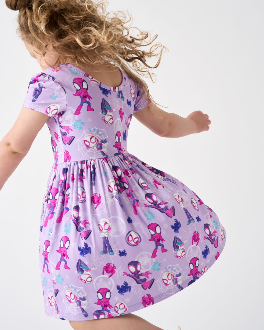 Child in motion wearing the Spidey & Friends Tiny Webs Skater Dress