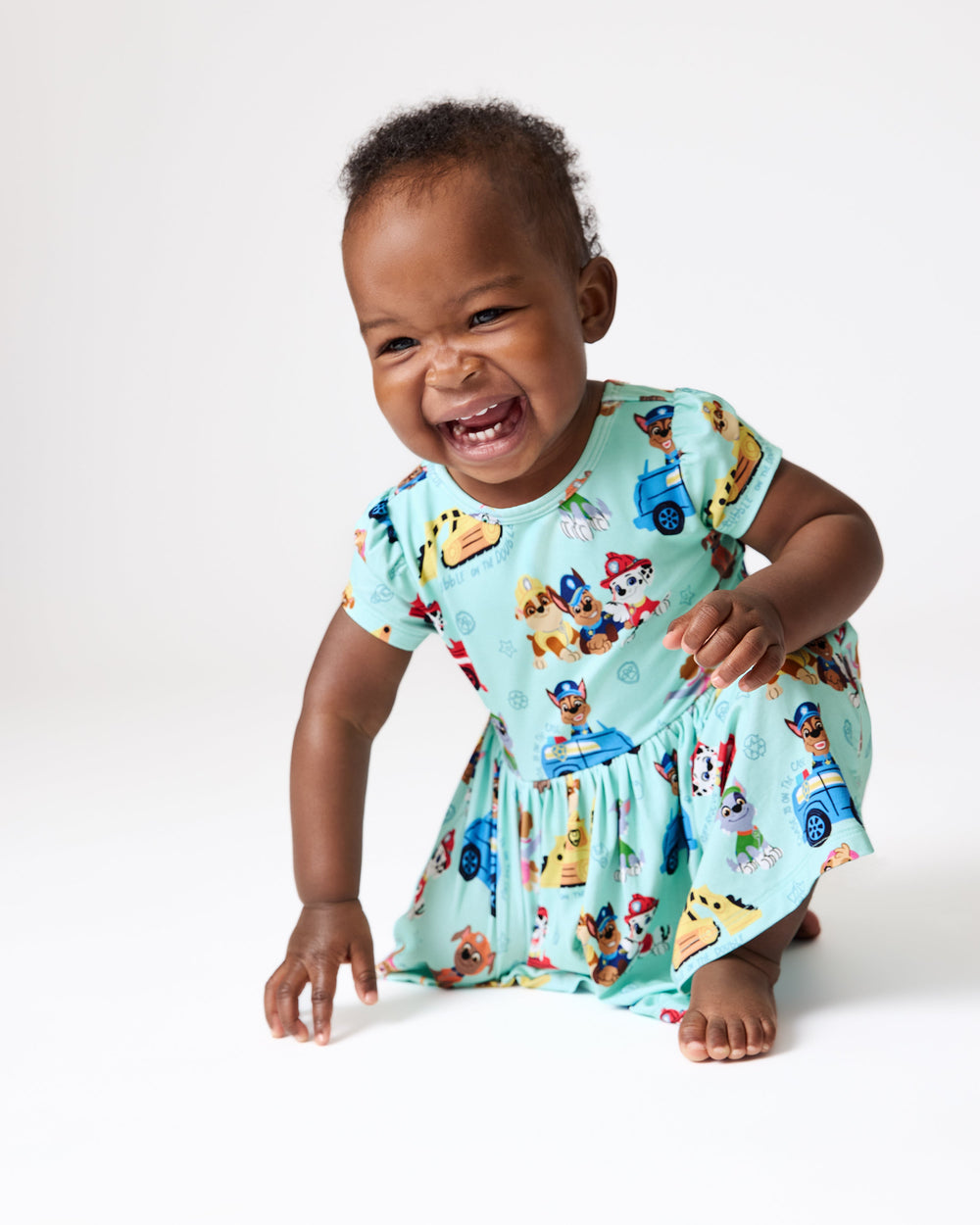 Crawling baby wearing the PAW Patrol Adventure Bay Heroes Skater Dress with Bodysuit