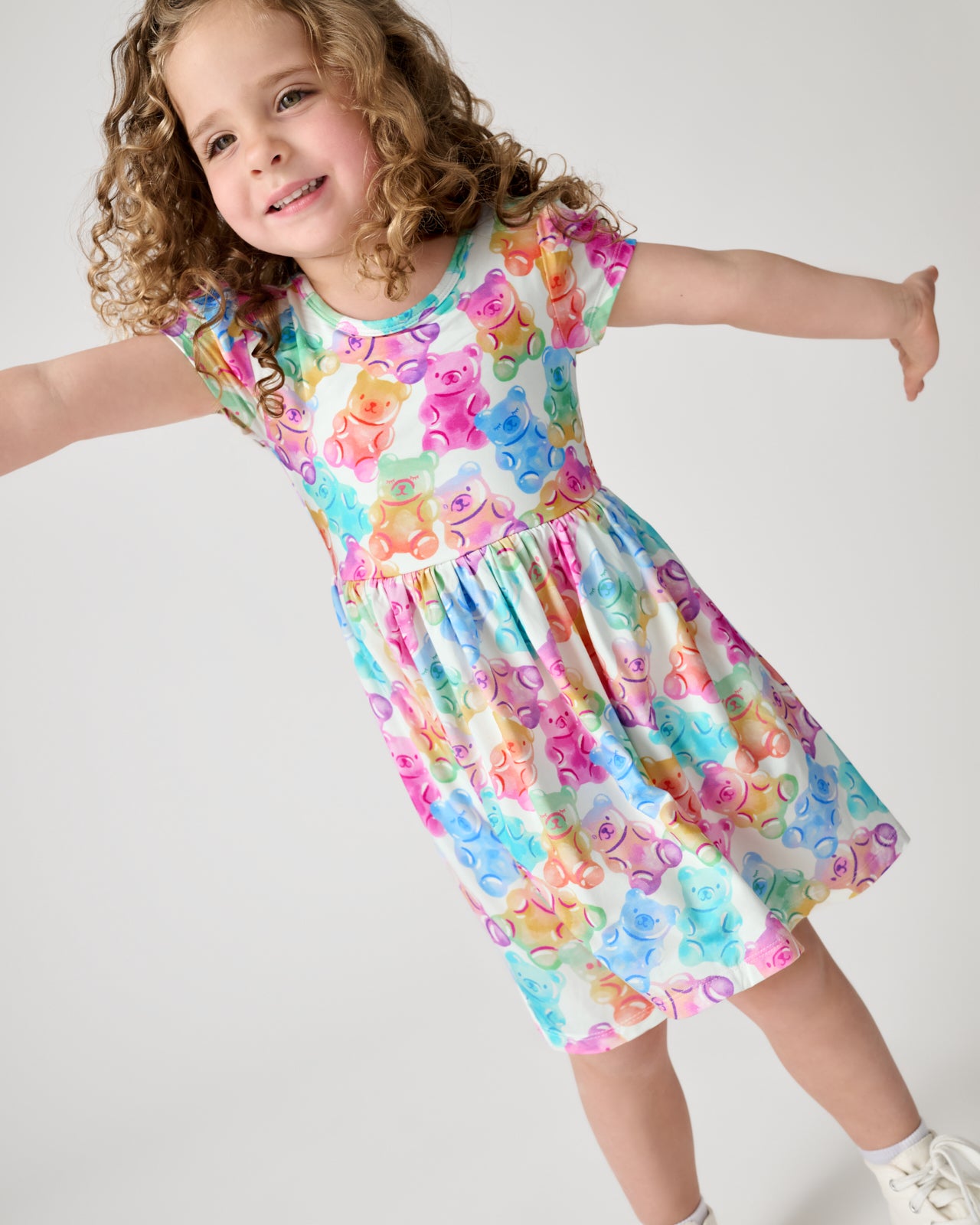 Posing girl wearing the Gummy Giggles Skater Dress