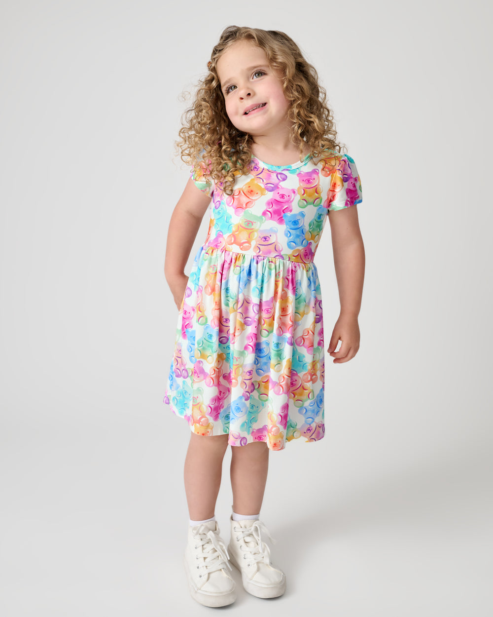 Standing child wearing the Gummy Giggles Skater Dress