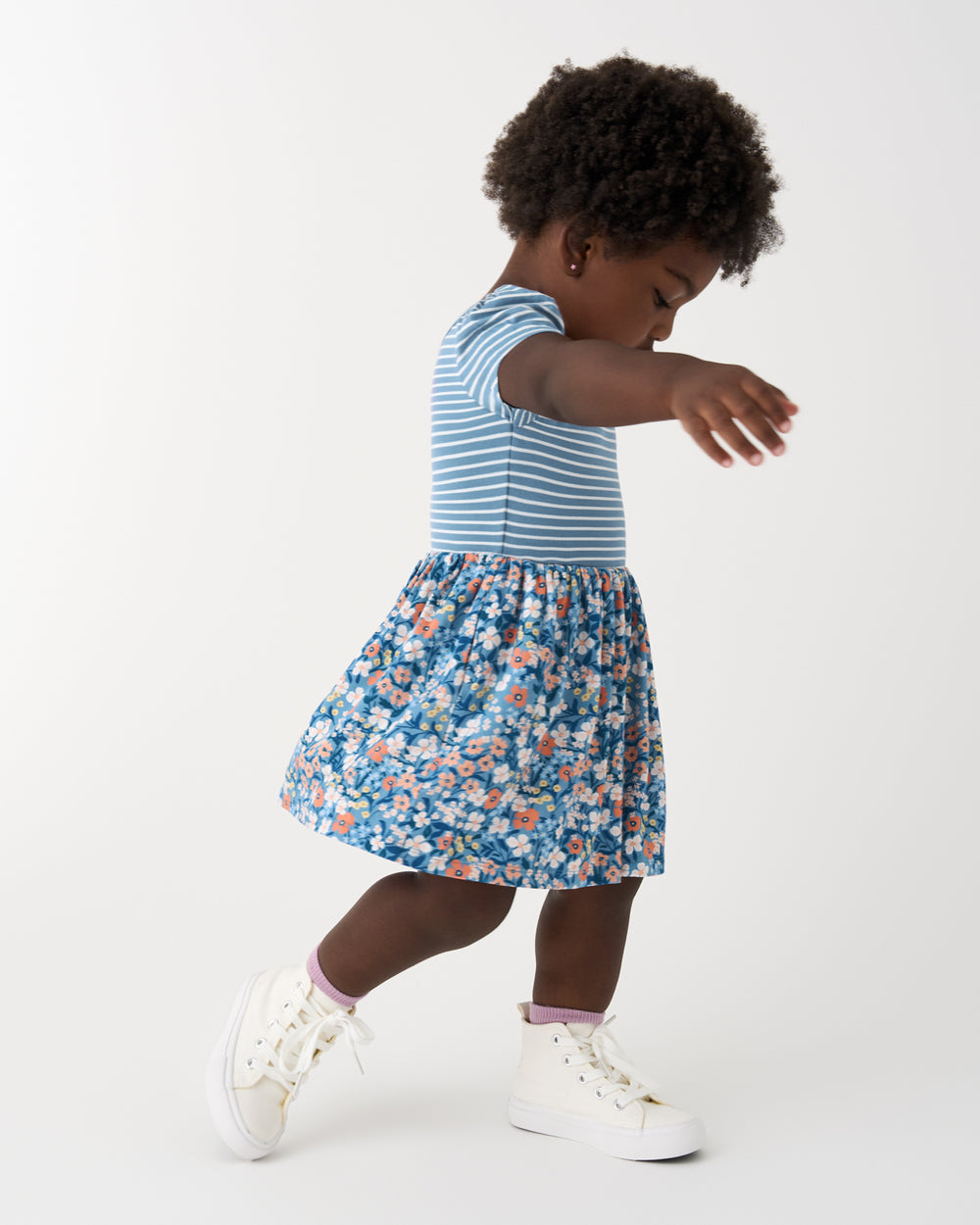 Girl in motion wearing the Petite Petals Skater Dress