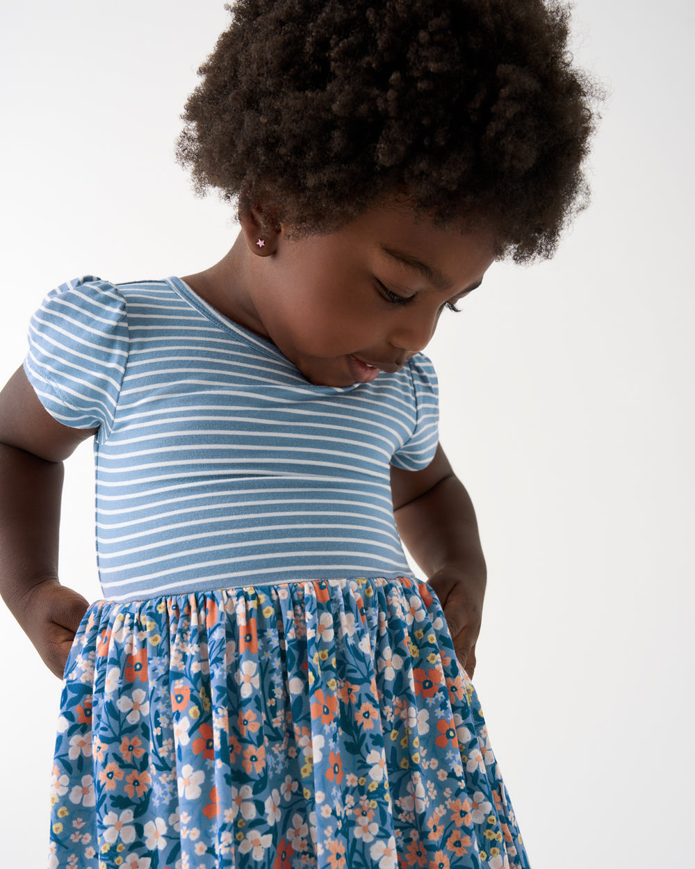 Close up of girl wearing the Petite Petals Skater Dress