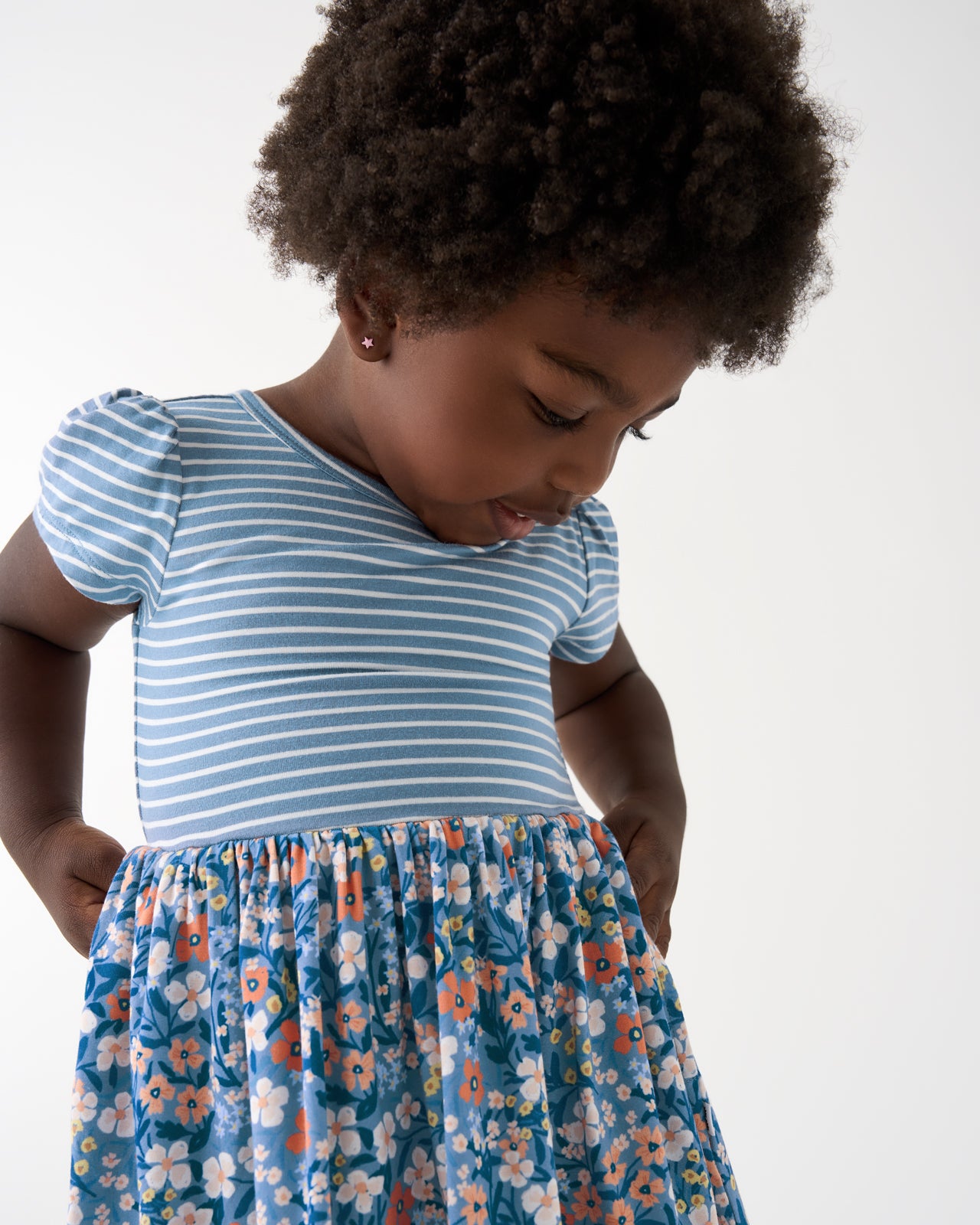 Close up of girl wearing the Petite Petals Skater Dress