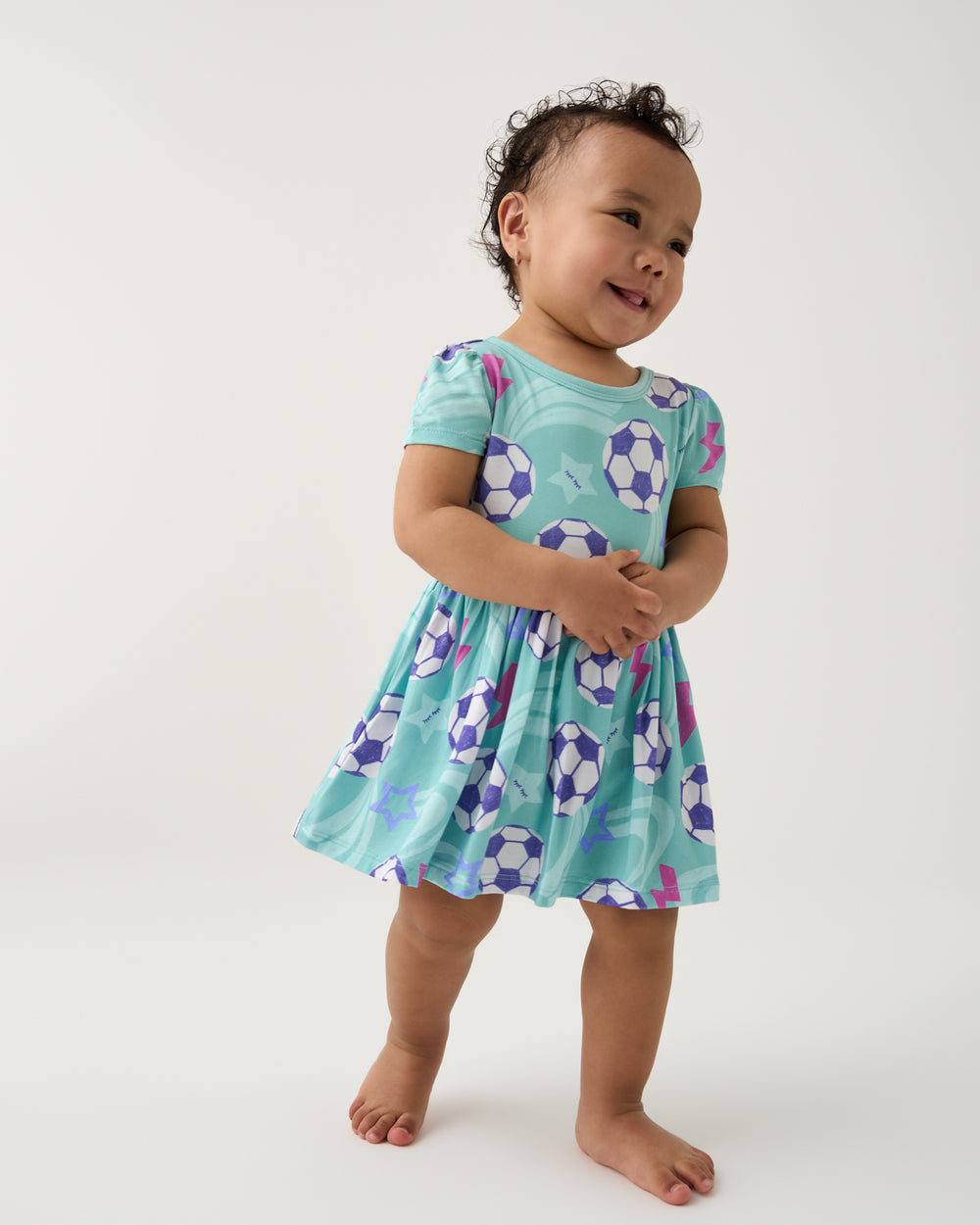 Baby wearing the Aqua Soccer Stars Skater Dress with Bodysuit