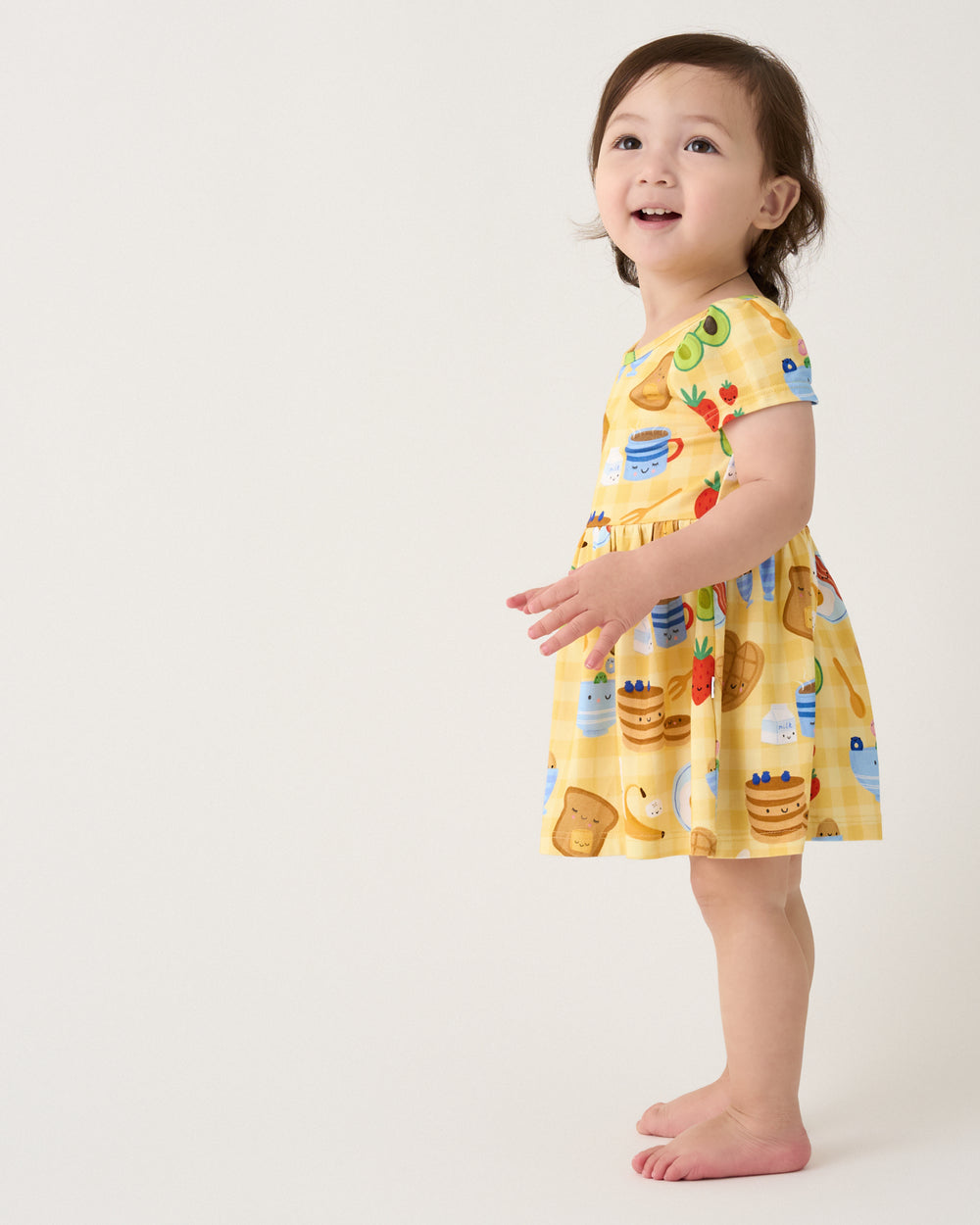 Side view of girl wearing the Breakfast Bunch Skater Dress with Bodysuit