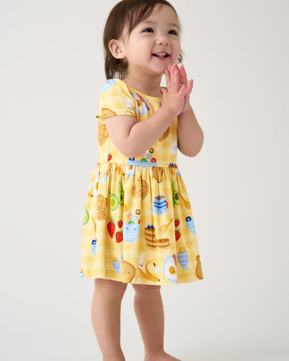 Girl wearing the Breakfast Bunch Skater Dress with Bodysuit