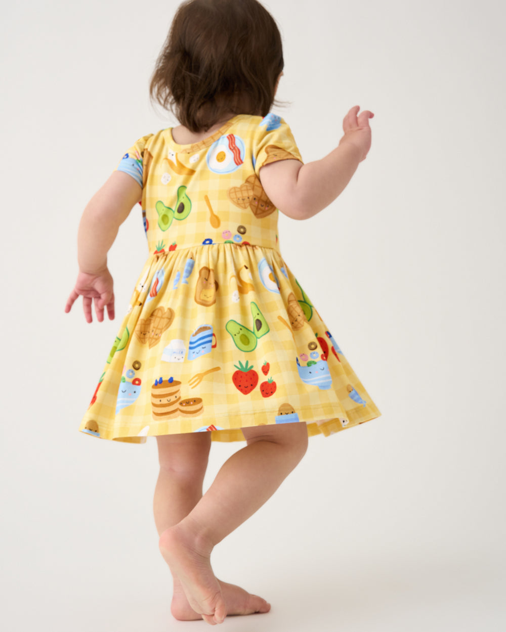 Back view of toddler wearing the Breakfast Bunch Skater Dress with Bodysuit