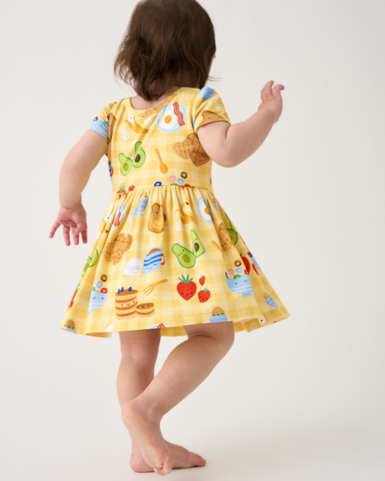 Back view of toddler wearing the Breakfast Bunch Skater Dress with Bodysuit