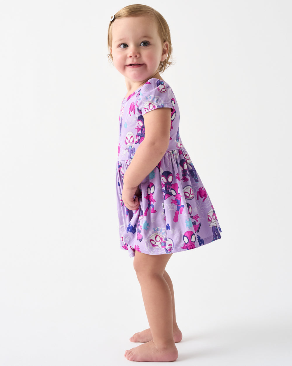 Standing toddler wearing the Spidey & Friends Tiny Webs Skater Dress with Bodysuit