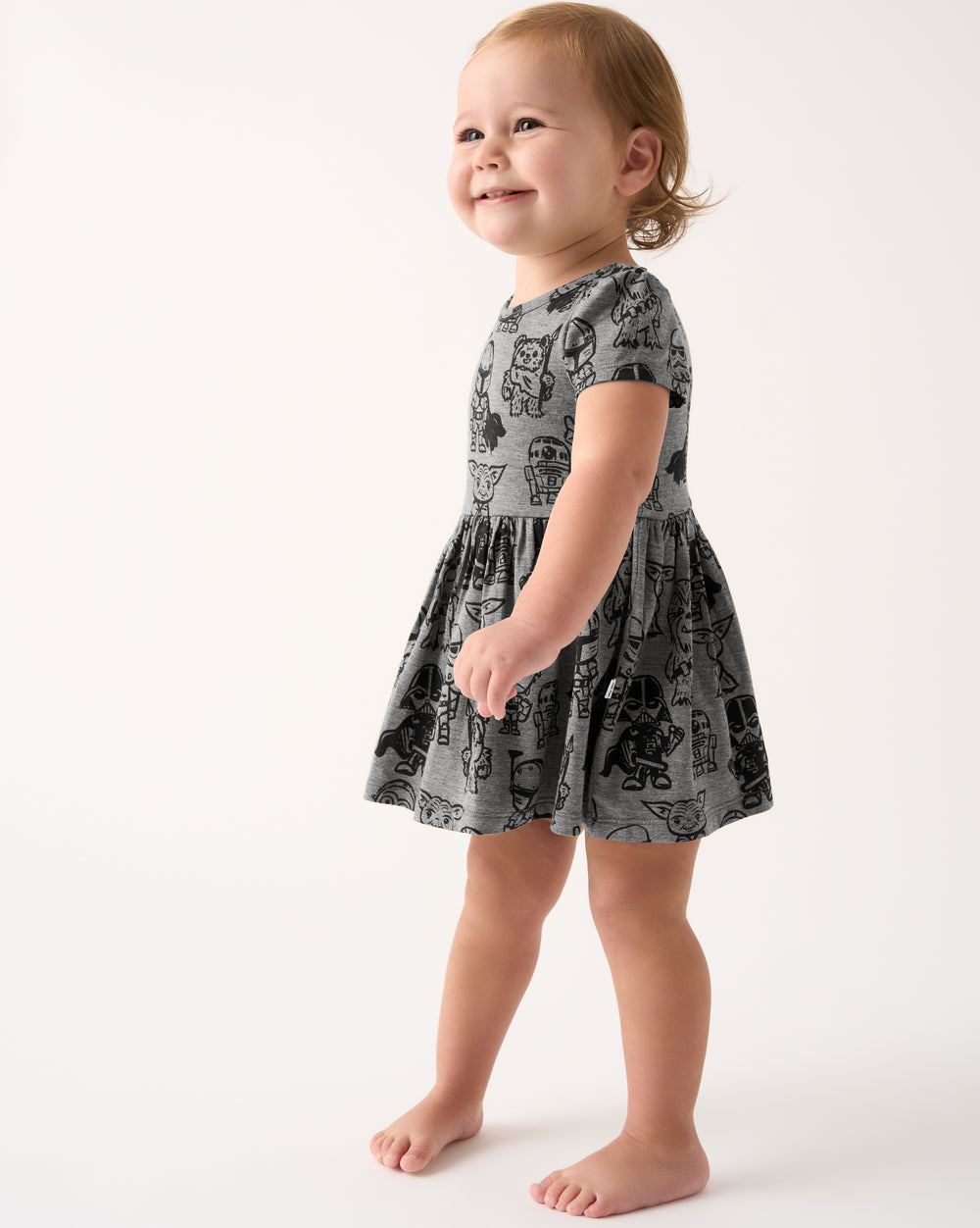 Standing toddler wearing the Star Wars Far, Far, Away Friends Skater Dress with Bodysuit