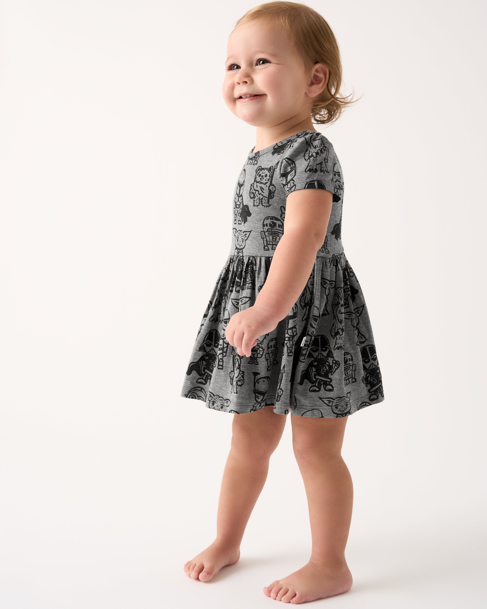 Standing toddler wearing the Star Wars Far, Far, Away Friends Skater Dress with Bodysuit