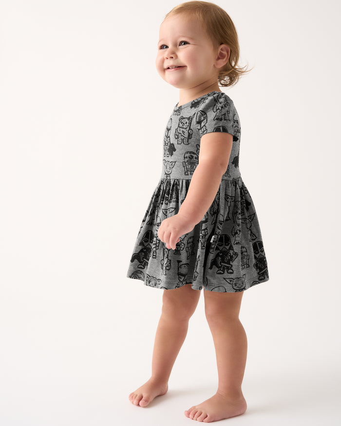 Standing toddler wearing the Star Wars Far, Far, Away Friends Skater Dress with Bodysuit