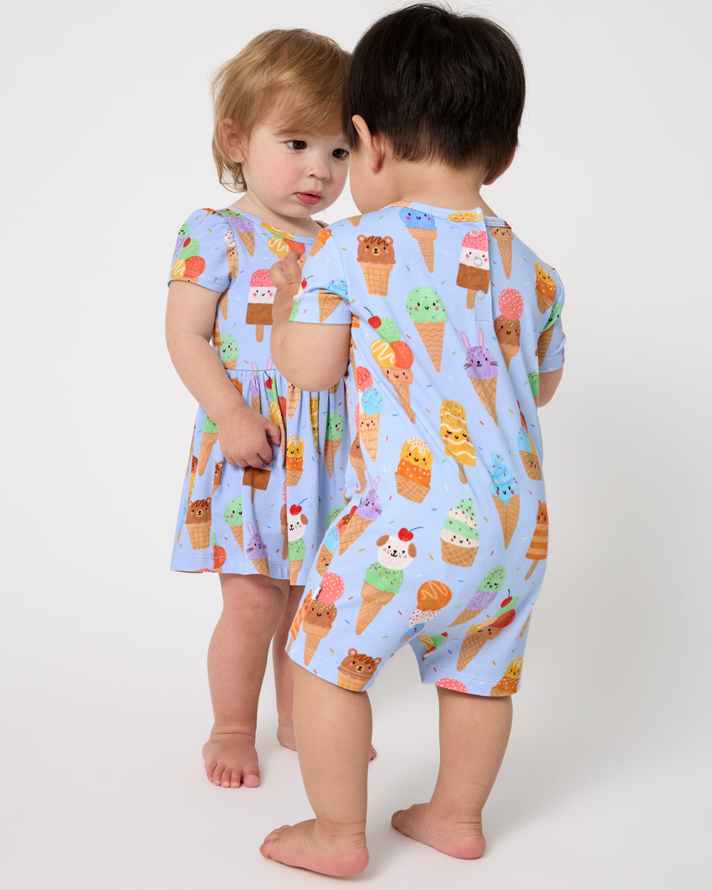 Two children wearing matching Scoop Squad play styles
